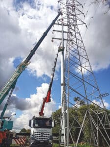 Auckland cranes GMK4100 and Hiab removing old tower lines 2023 March.